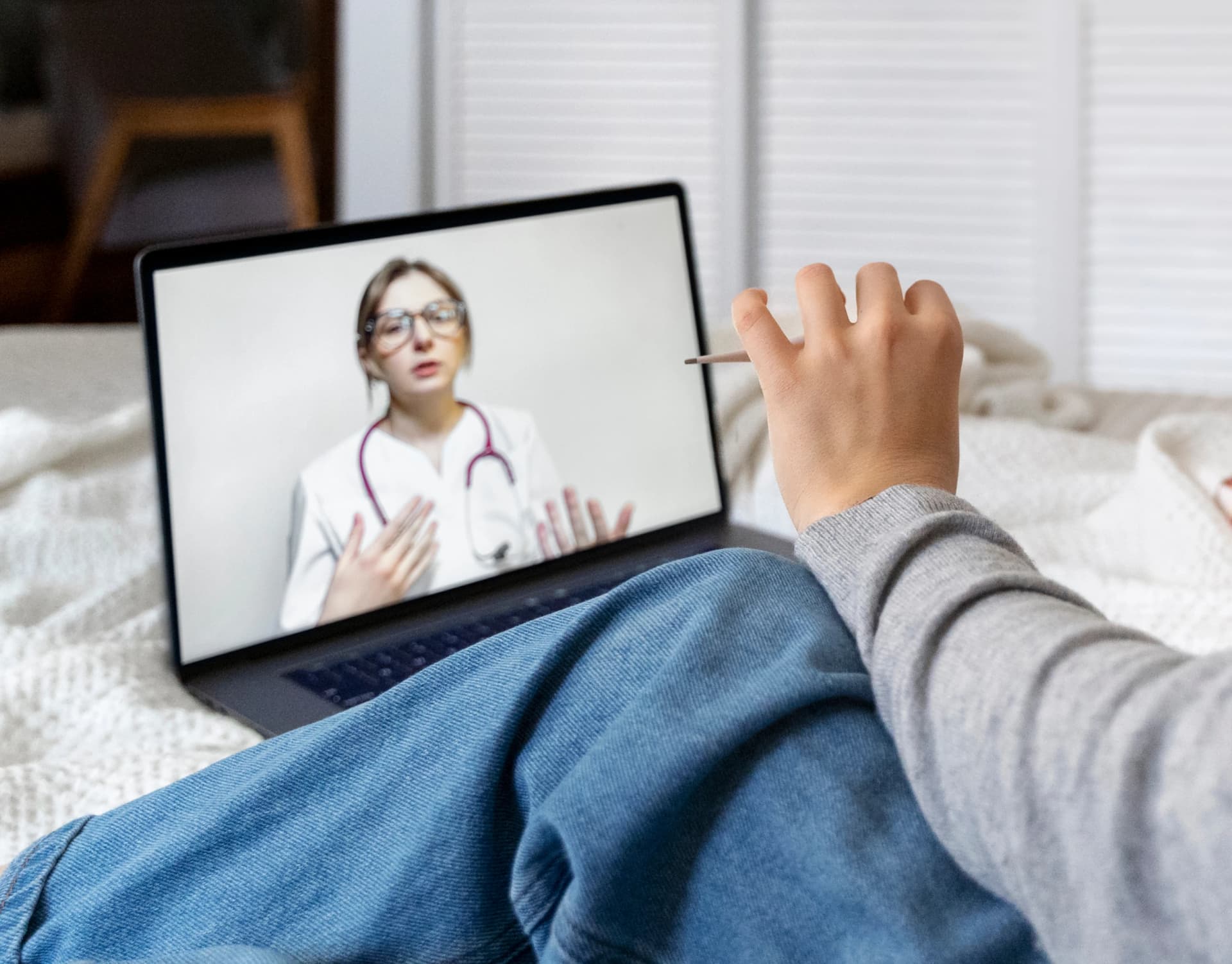 Person on a telehealth video call with a doctor