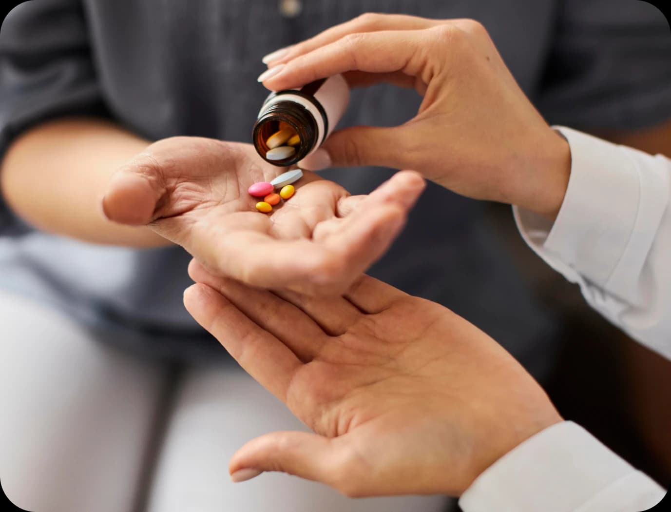Physician handing medication to a patient during a consultation